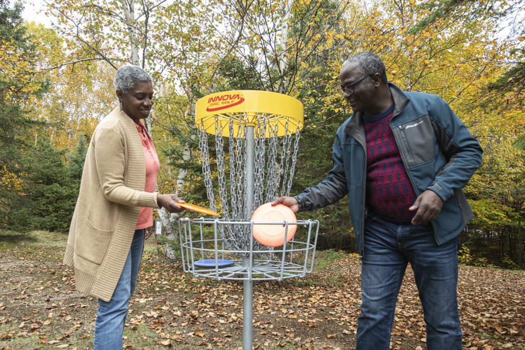 couple retrieving discs from holder