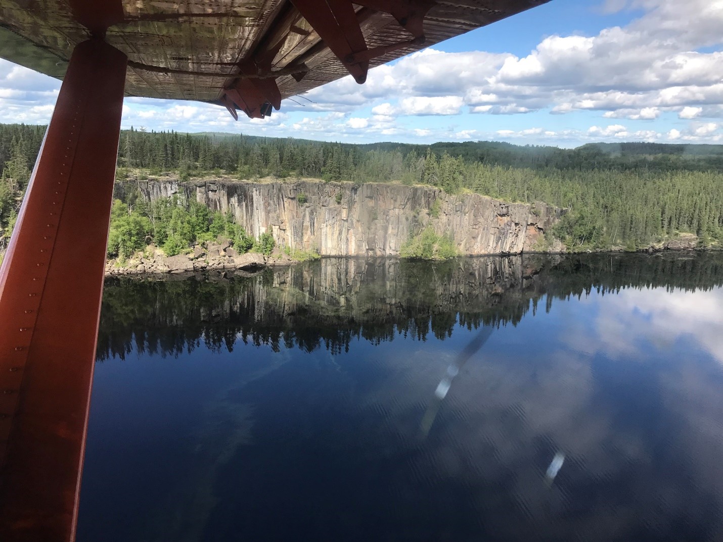 Aerial view of a lake and cliff face in the park