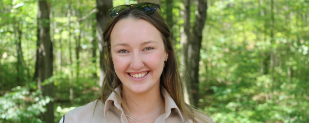 Woman in Ontario Parks uniform smiling