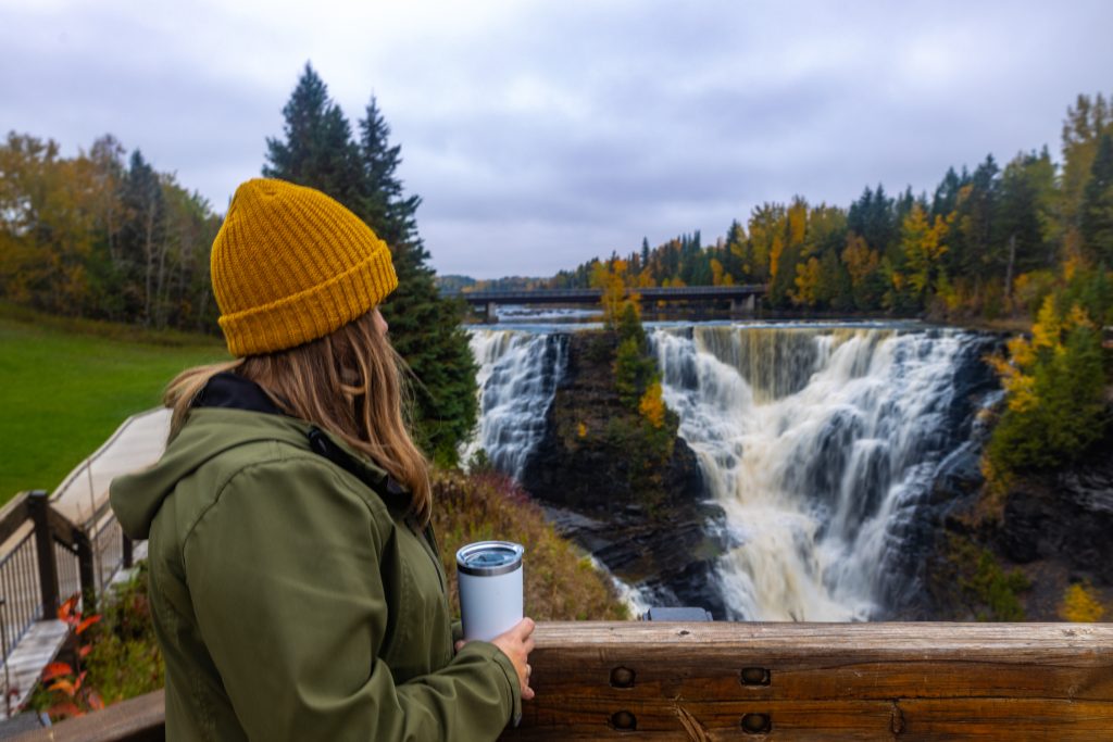 woman on boardwalk above waterfall