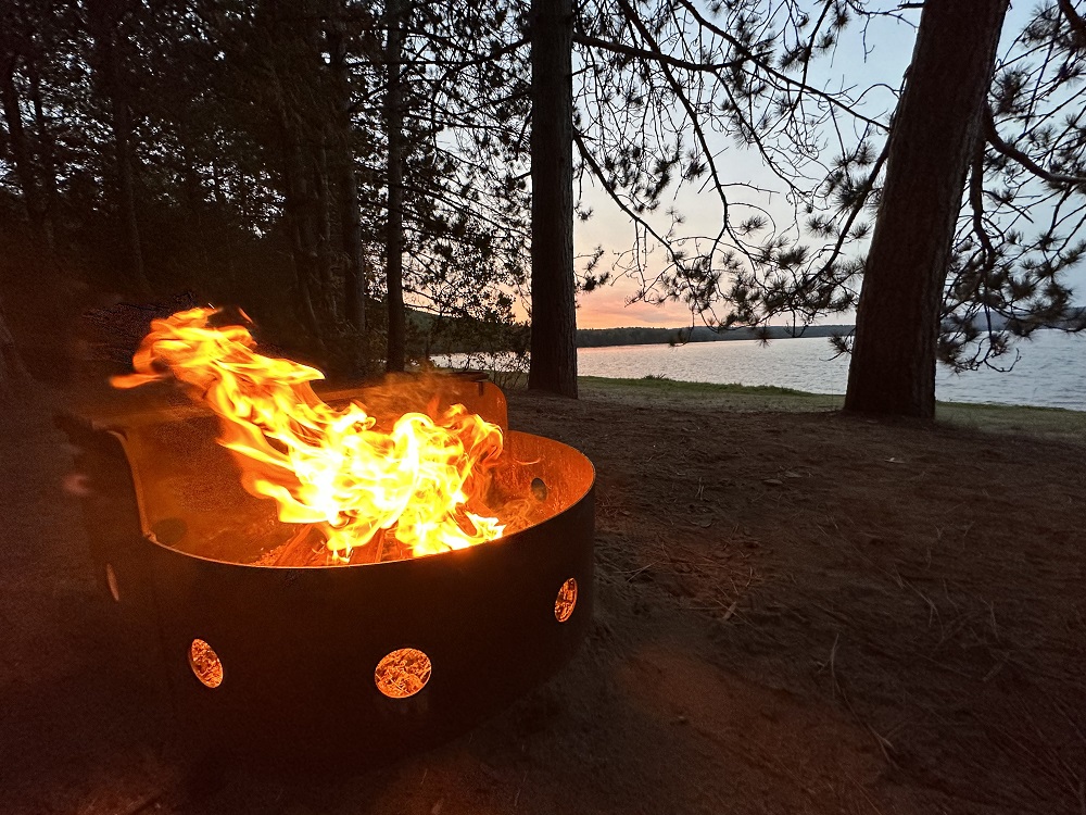 Campfire with sunset on riverfront site