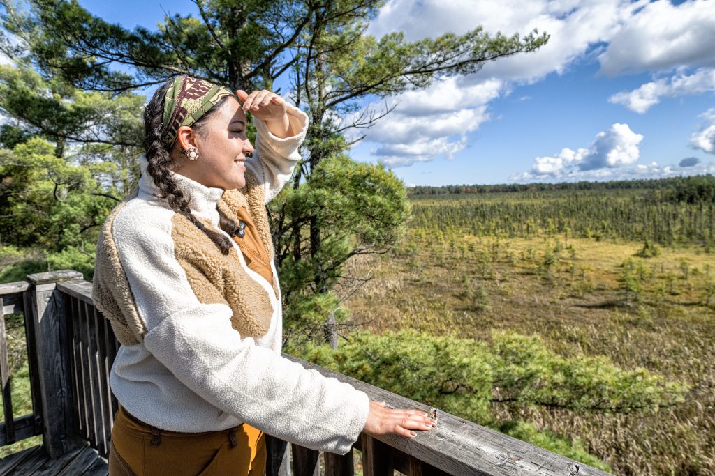 woman gazing out from boardwalk platform