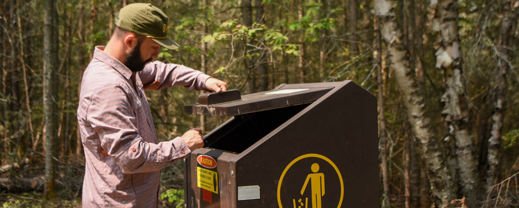 man throwing out trash