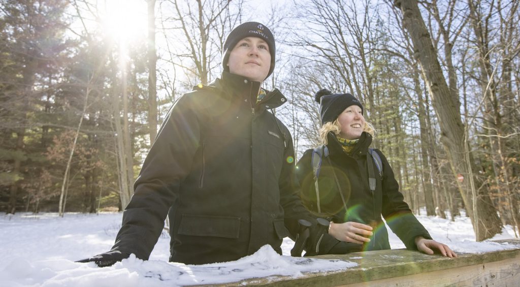 A couple exploring a trail in winter.