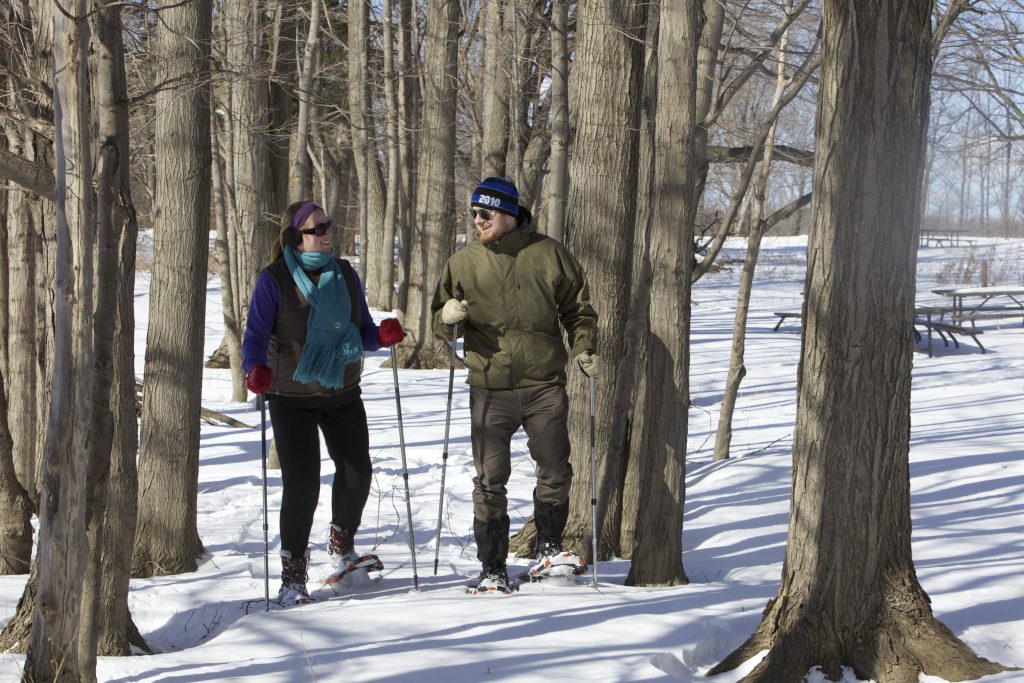 Couple snowshoeing among the trees