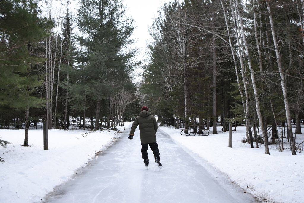 person skating through forest