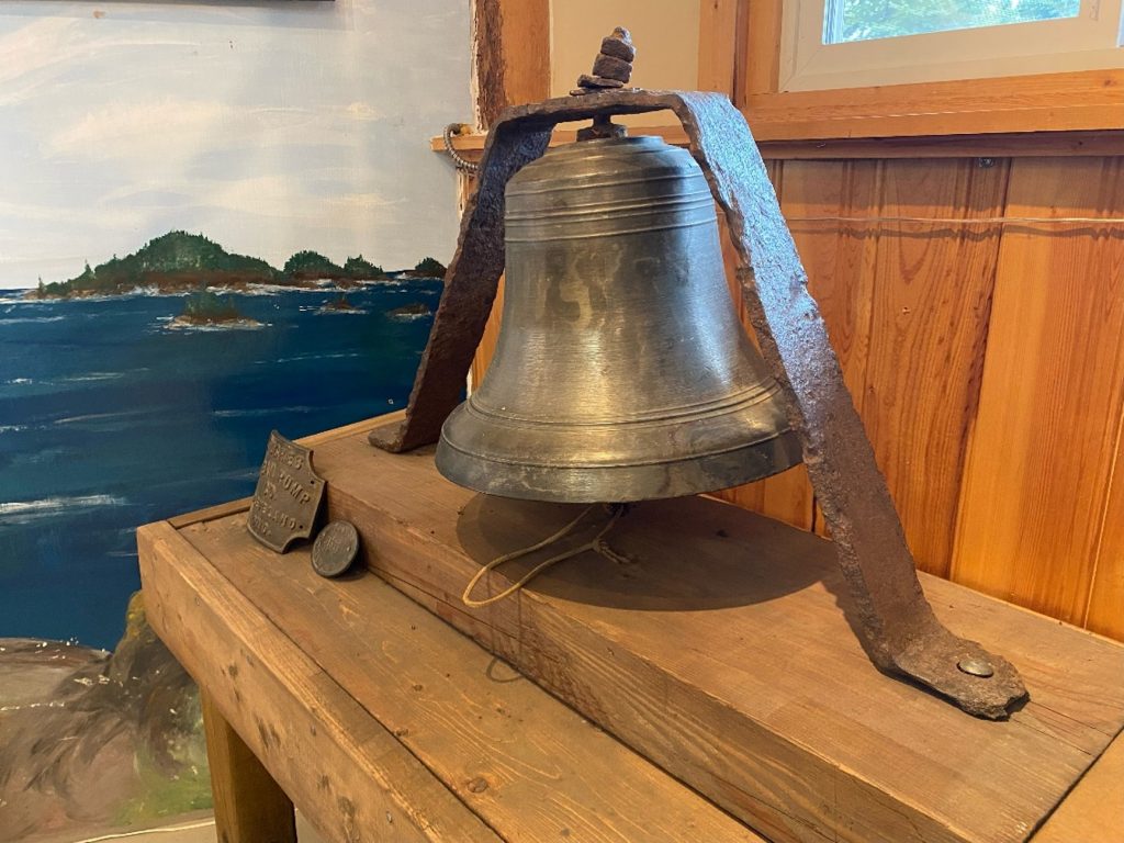 old bell on wooden plank