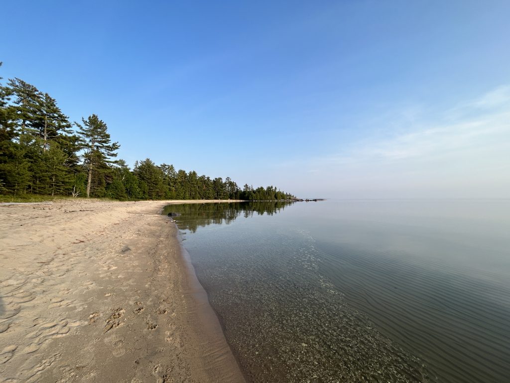 Sandy beach and clear lake