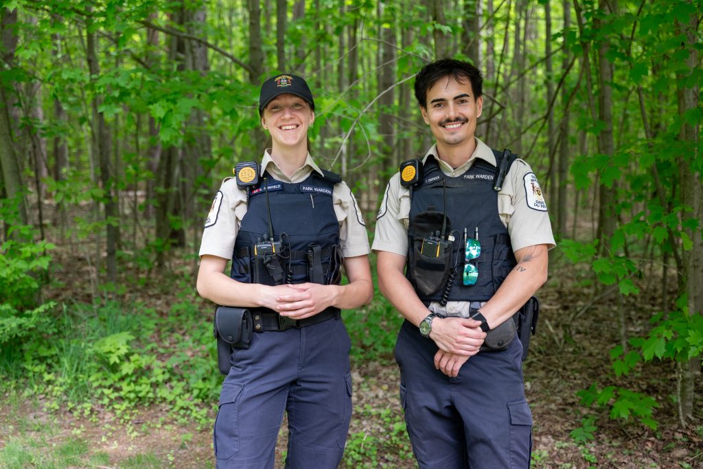 two park wardens smiling at camera