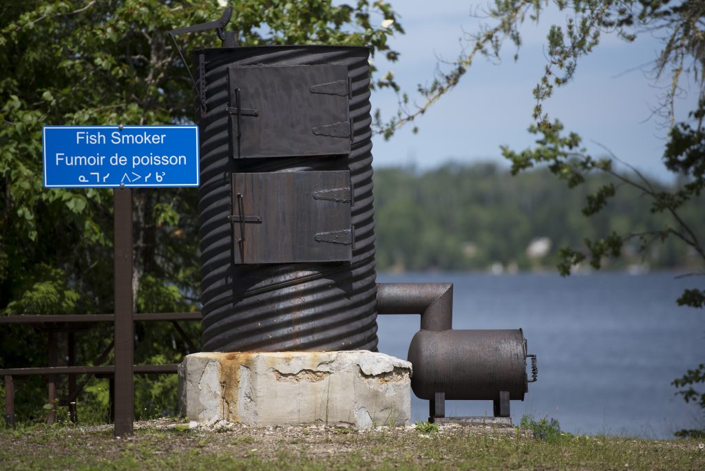 fisher smoker with sign reading "fish smoker"