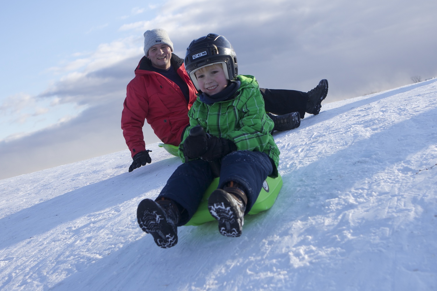 parent and child tobogganing