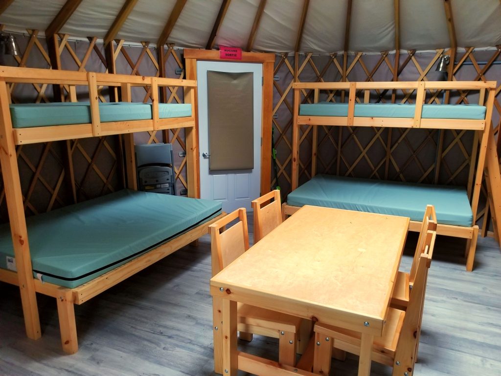 interior of yurt with bunk beds and dinner table
