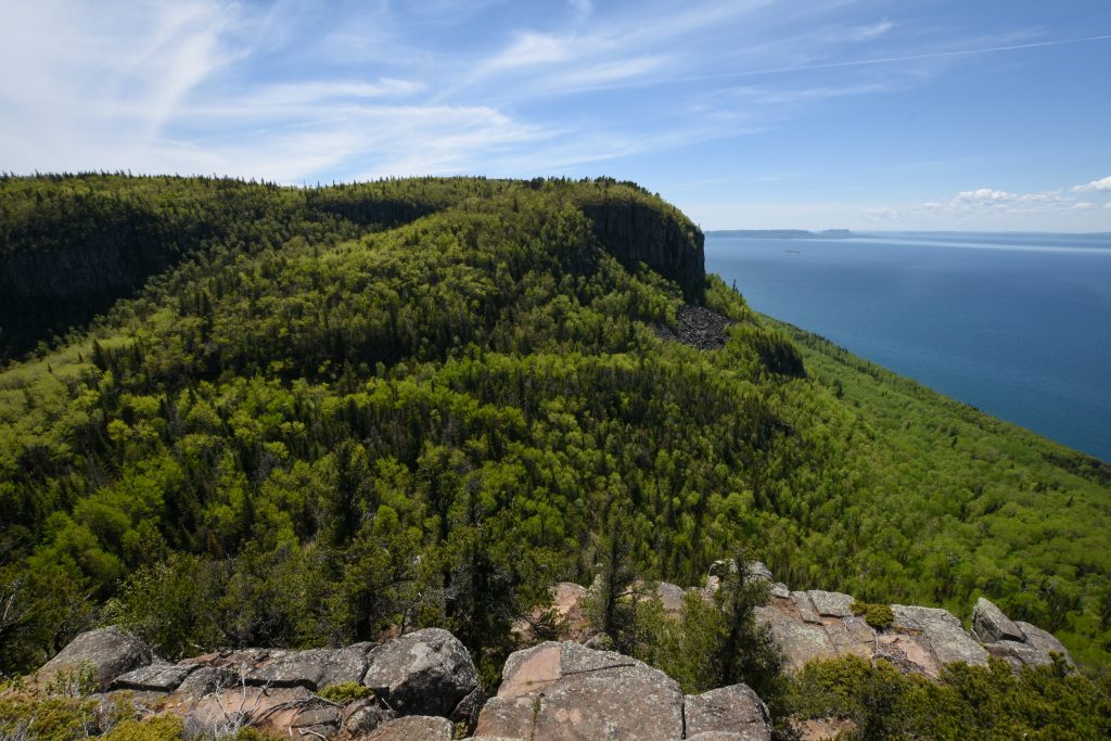 large, treed cliffs overlooking lake