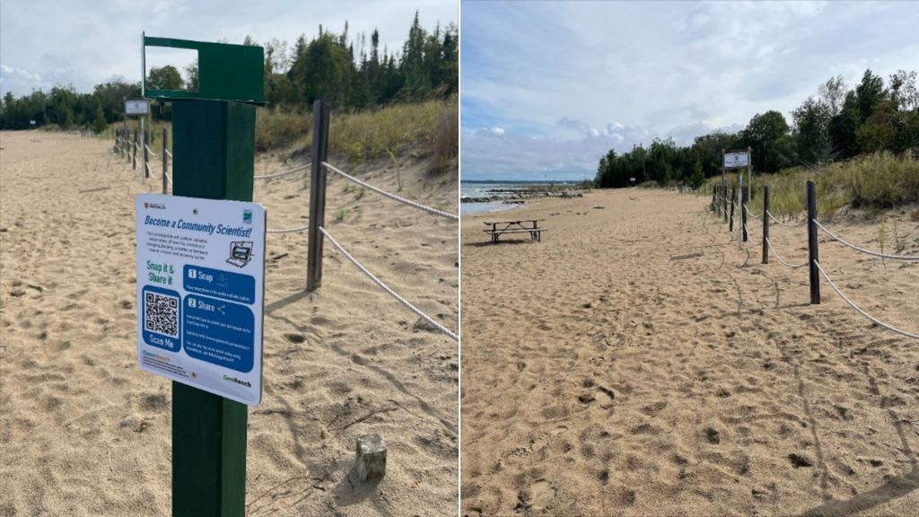 frame on metal post, beach with picnic table and roped fencing