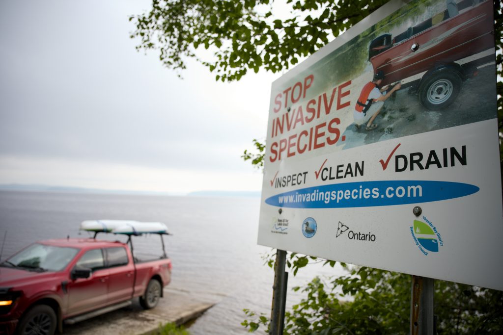 sign at park boat launch that read "Stop invasive species. Inspect, clean, drain."
