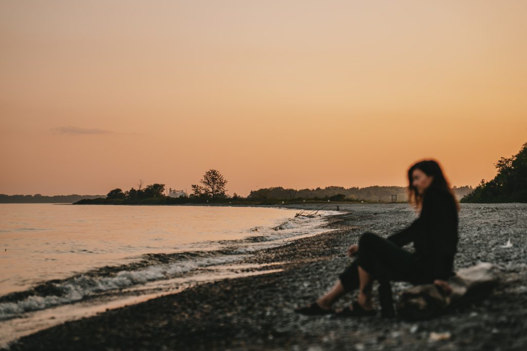 woman on pebbly shoreline