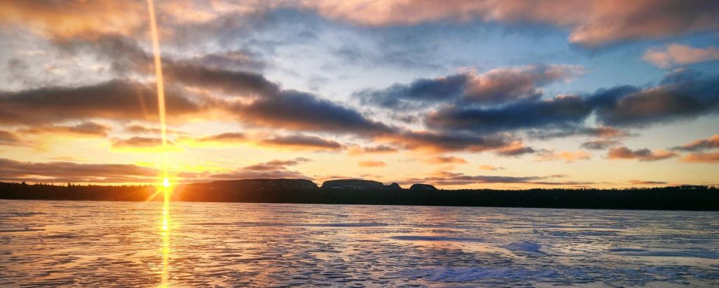 sun setting over geological formation