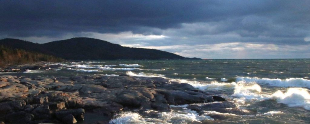 waves crashing into rocky shore during storm